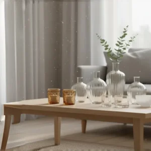 A visually inspiring arrangement of diverse, affordable decorative glass vases, bowls, and objects on a clean shelf, highlighting how budget pieces can look luxurious.