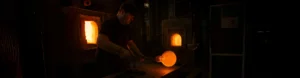 Artisans shaping molten glass at HONOR LIVING Glass workshop
