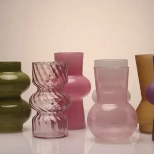 Bright spring flowers arranged in colorful glass vases for fresh spring home decor inspiration